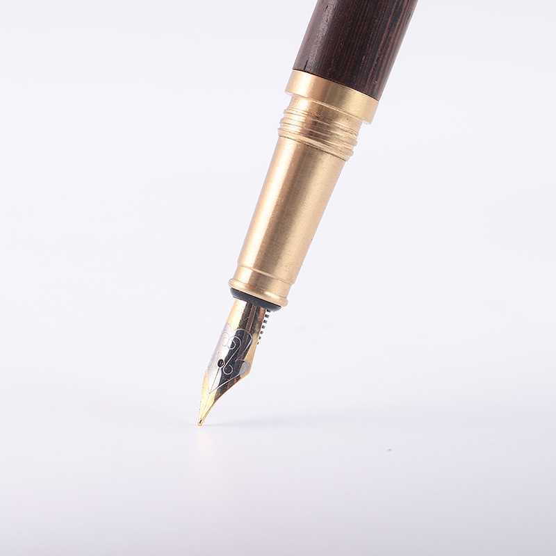 Brass, wooden, and iridium-plated gold pen with ink sac