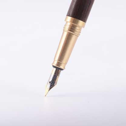 Brass, wooden, and iridium-plated gold pen with ink sac