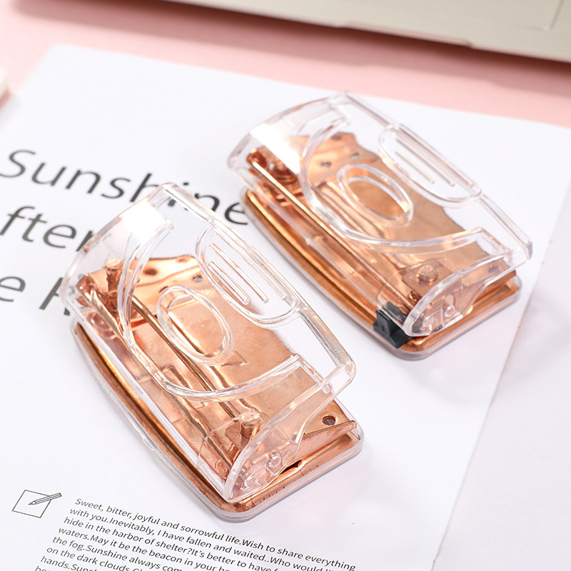 Rose gold metallic transparent manual double-hole loose-leaf notebook hole punch for students and office supplies.