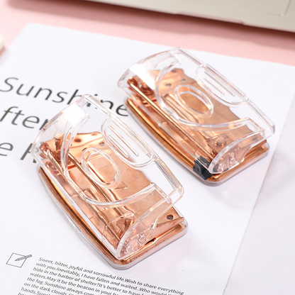 Rose gold metallic transparent manual double-hole loose-leaf notebook hole punch for students and office supplies.