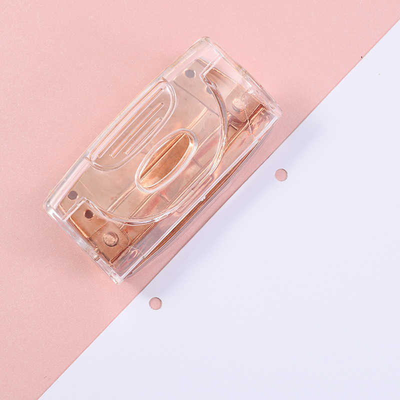 Rose gold metallic transparent manual double-hole loose-leaf notebook hole punch for students and office supplies.
