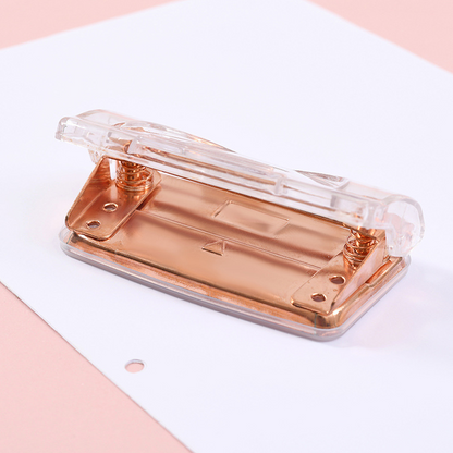 Rose gold metallic transparent manual double-hole loose-leaf notebook hole punch for students and office supplies.